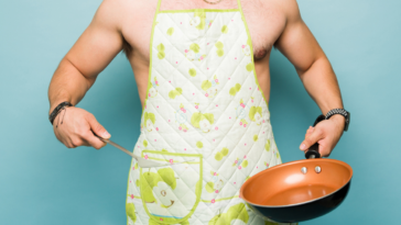 Man wearing only a cooking apron