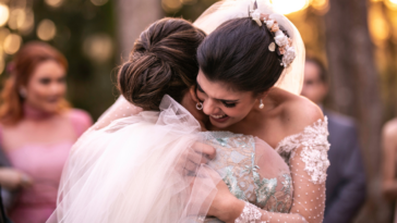 A bride hugging another woman.