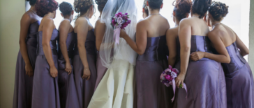 A bride surrounded by bridesmaids.