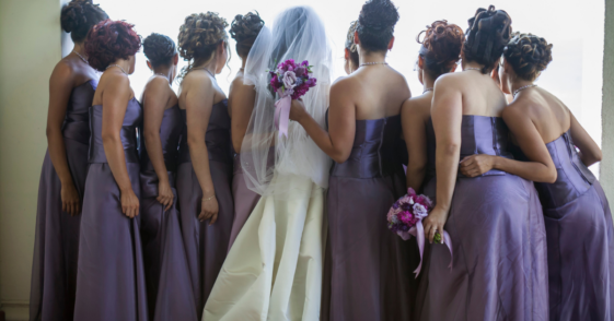 A bride surrounded by bridesmaids.
