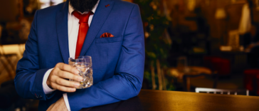 Man drinking in suit