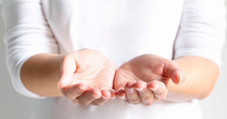 Close-up of a woman's open palms, two hands for prop up for something; or begging for something. selective focus inside palms.