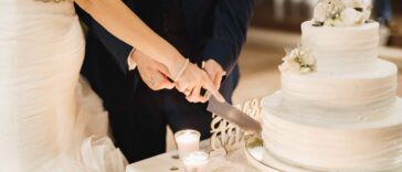 Bride and groom slicing wedding cake