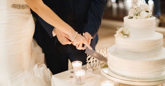 Bride and groom slicing wedding cake