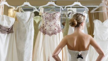 Bride looking at wedding dresses.