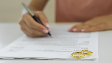 Woman signing divorce papers