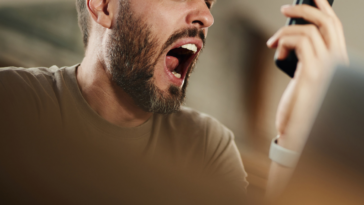 Man yelling after reading text message