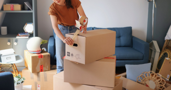 young woman packing moving boxes