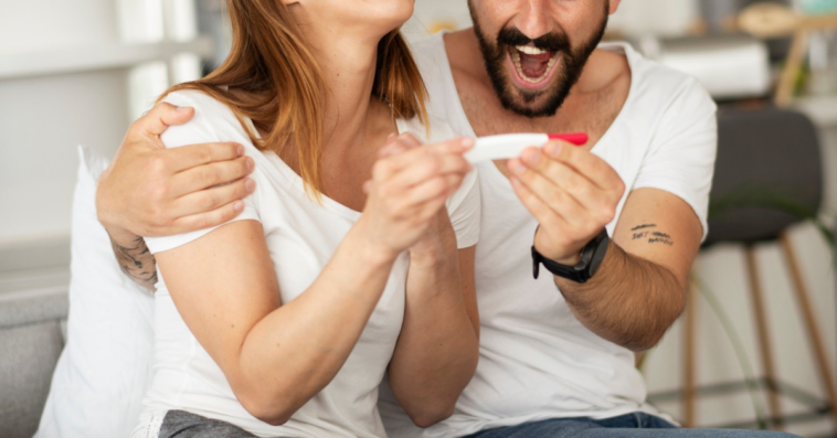 young couple excited about pregnancy test