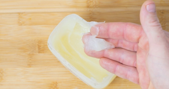 fingers scooping petroleum jelly