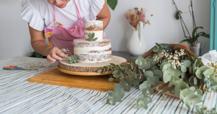woman decorating a wedding cake