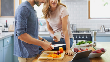 couple preparing food together in kitchen
