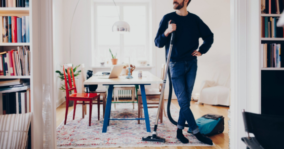 man standing with vacuum cleaner