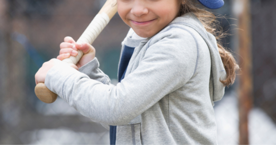 Young girl playing baseball