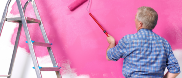 Man painting wall pink