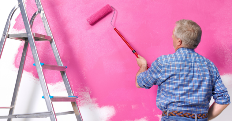 Man painting wall pink