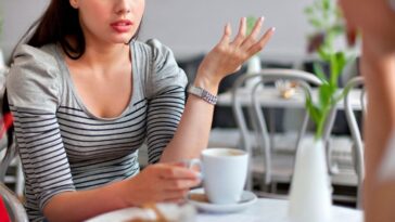 Young women deep in conversation, having coffee.