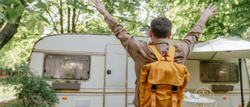 young man excited to see an RV in the woods