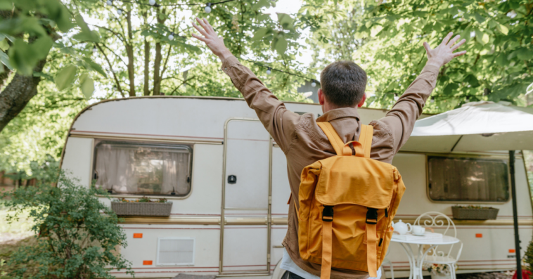 young man excited to see an RV in the woods