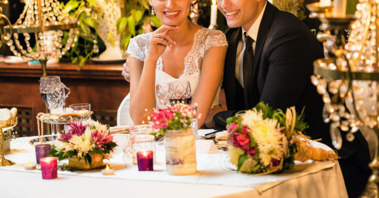 bride and groom seated at lavish table
