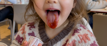child eating ketchup