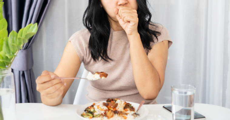 Woman having an allergic reaction at dinner