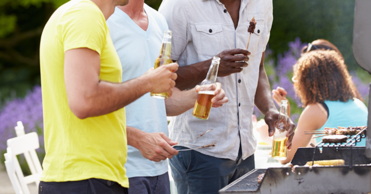 Men drinking beers and grilling kebabs.