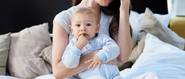 Unhappy woman holding someone else's baby