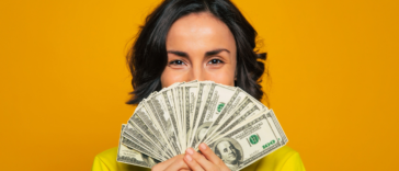 Excited woman holding money