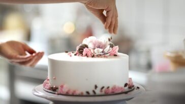 Person decorating cake