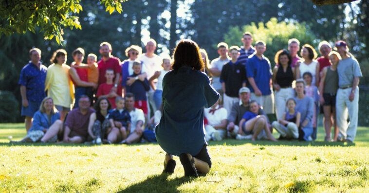 Person setting up to take group photo