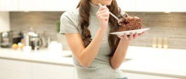 Woman snacking on cake