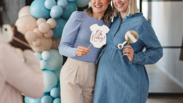 two people pose for photo at baby shower