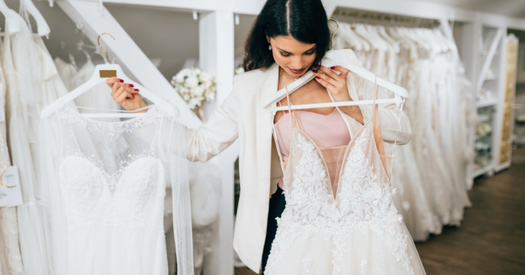 Woman holding wedding dresses