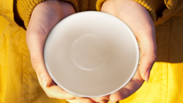 Girl holding an empty dish.