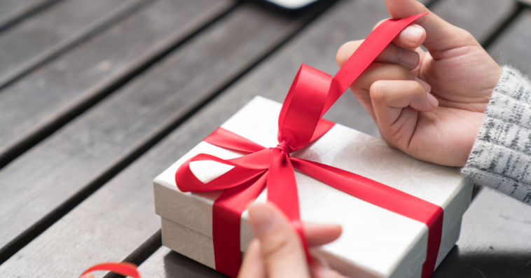 A woman unwrapping a present.