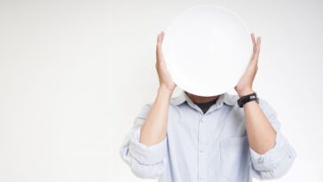 Young man Covering face with white plate
