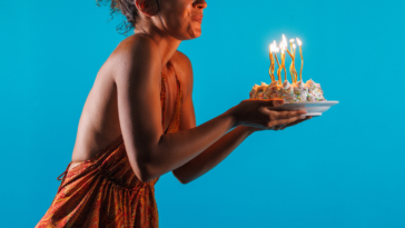 Teen girl blowing out birthday candles