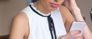 upset woman looking at her phone