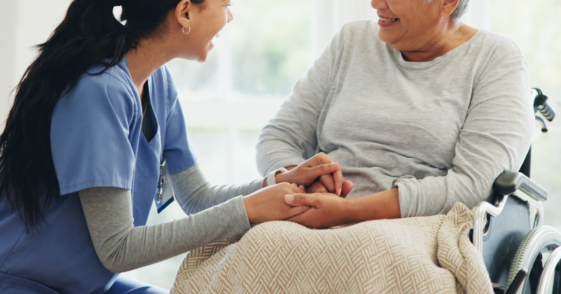 Woman being attended to in nursing home