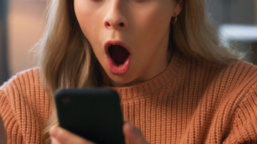Shocked woman looking at her phone