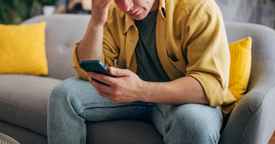 Upset man looking at his phone