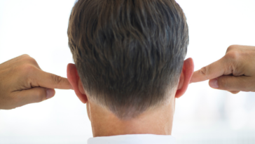 Man covering his ears