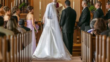 Bride and groom standing at altar during wedding ceremony.