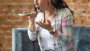 A woman screaming into her phone.