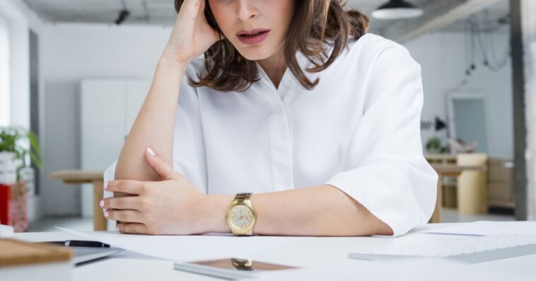 Upset woman at a desk