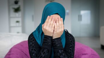 Muslim woman appearing distressed