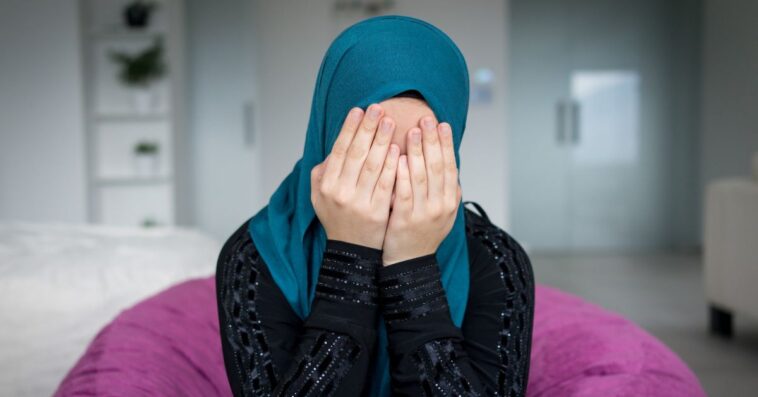 Muslim woman appearing distressed