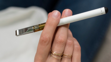 woman holding vape pen