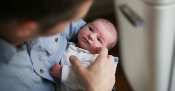 parent holding newborn baby